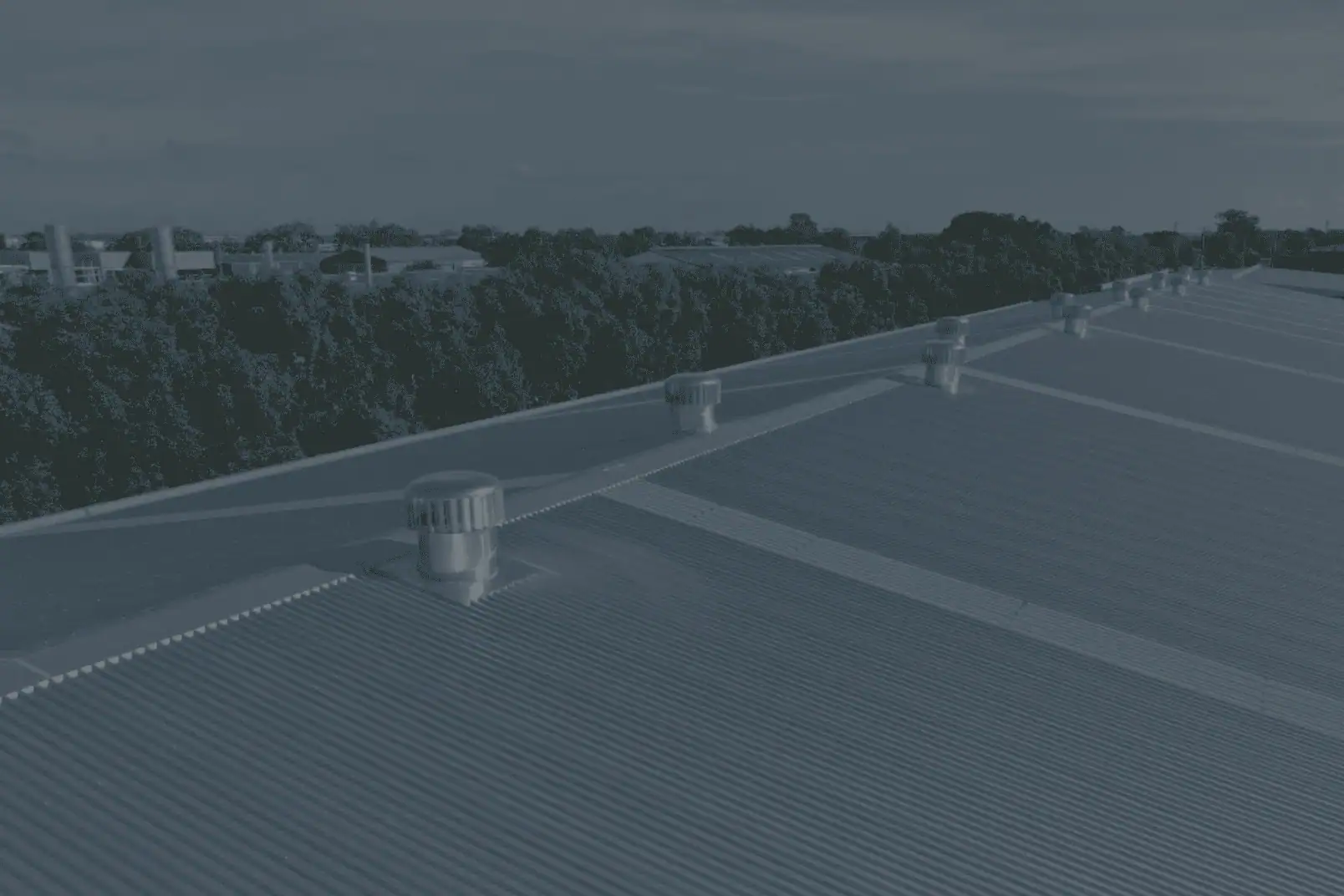 A large commercial building with shiny new metal roofing